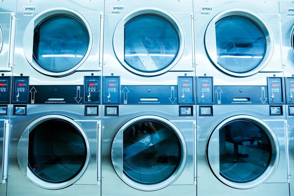 A row of modern washing machines in a laundromat